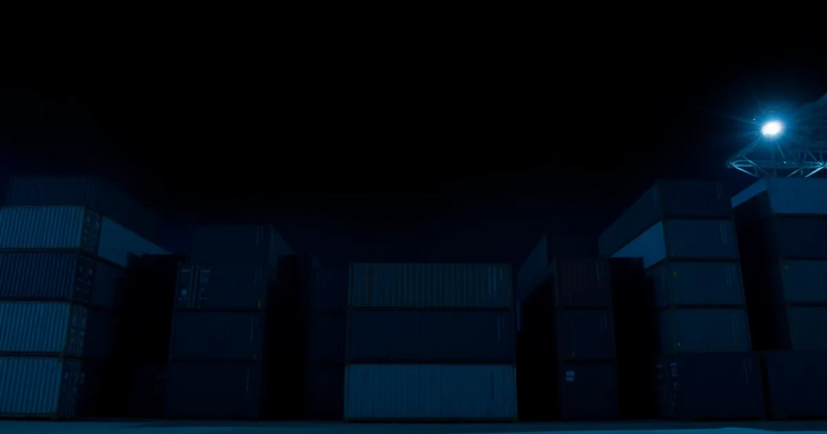 Stacked shipping containers under floodlight at night, illustrating FATCA letter from your UK bank