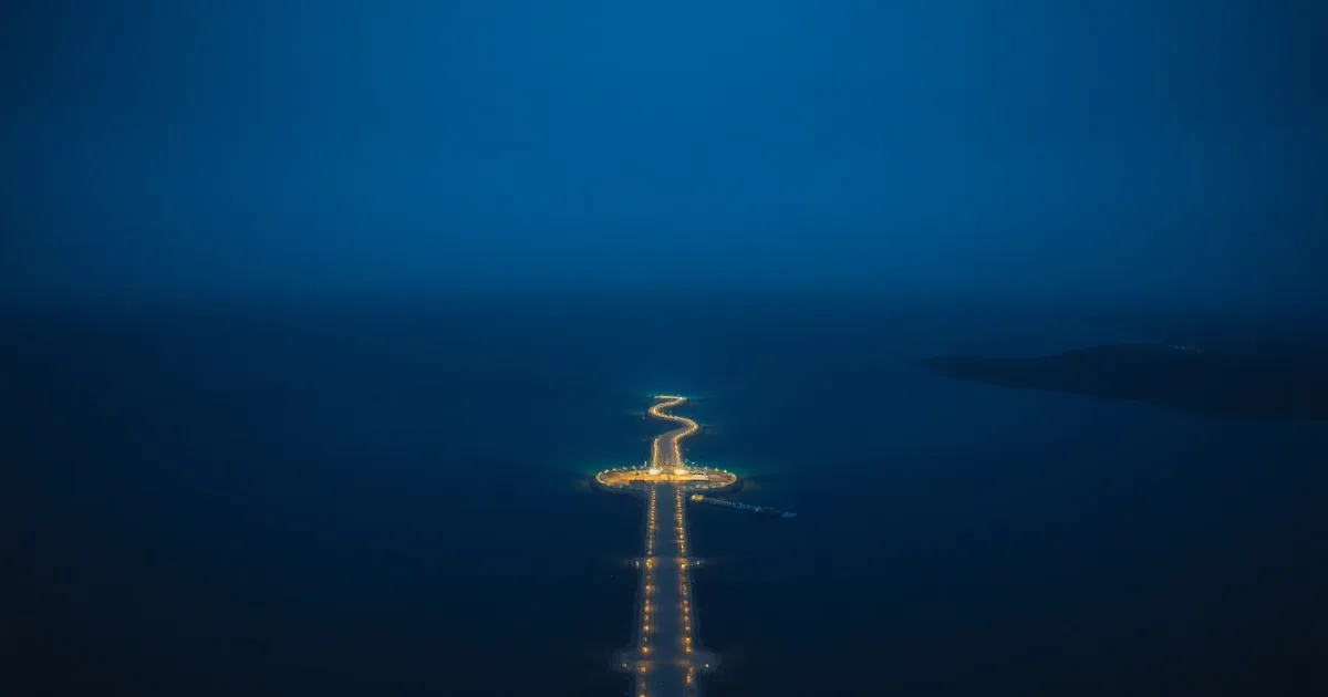 A stone causeway running out across still water at dusk, illustrating Restricted stock units: UK and US tax