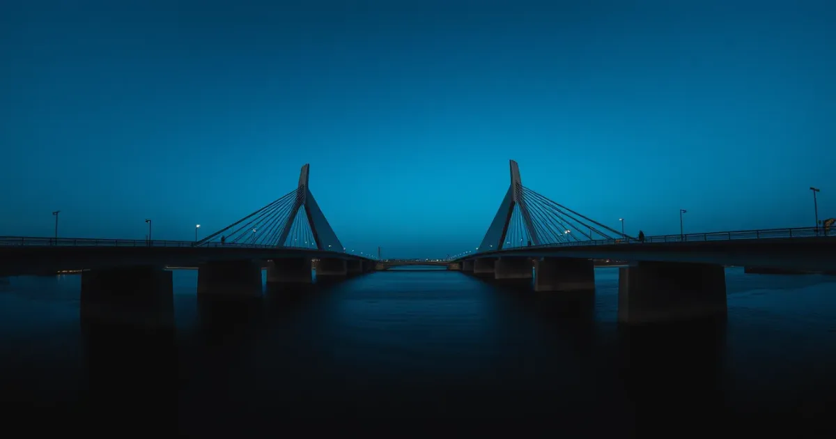 Two bridges reaching across the same dark water, illustrating salary sacrifice and your US tax return