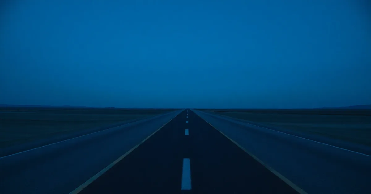 Two roads of different surfaces meeting on an empty plain, illustrating school fees, tax and paying from abroad
