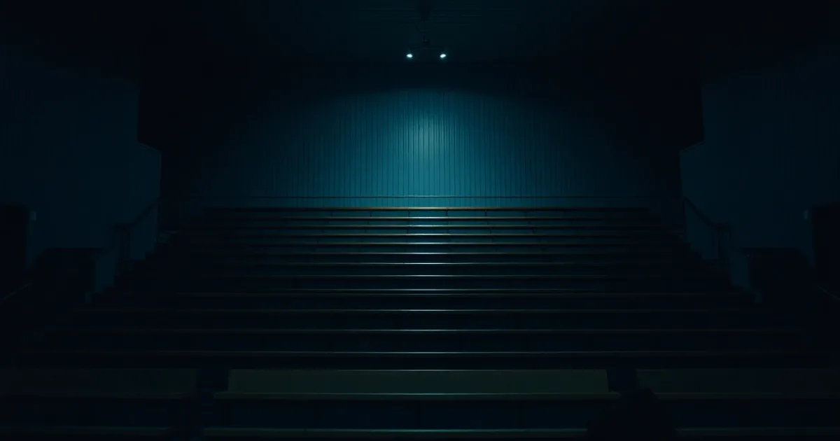 An empty chamber of tiered wooden benches, illustrating UK tax year of arrival explained