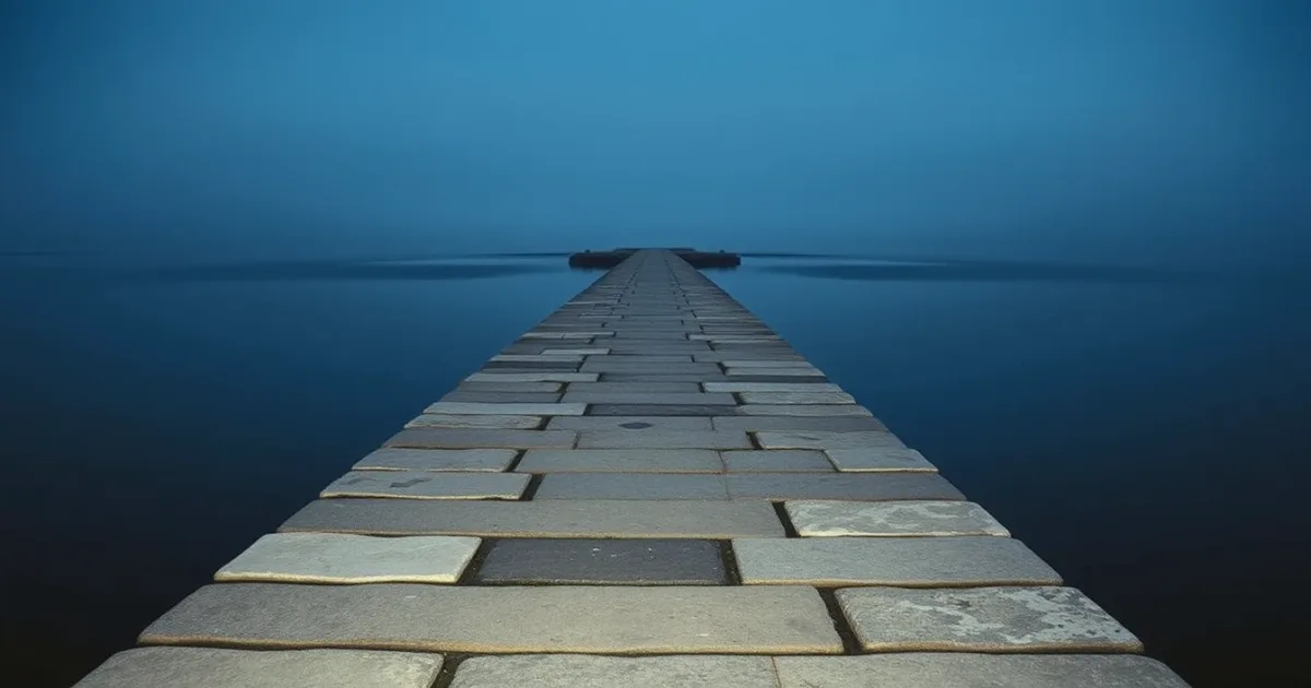 A stone causeway running out across still water at dusk, illustrating UK to US transfer pricing