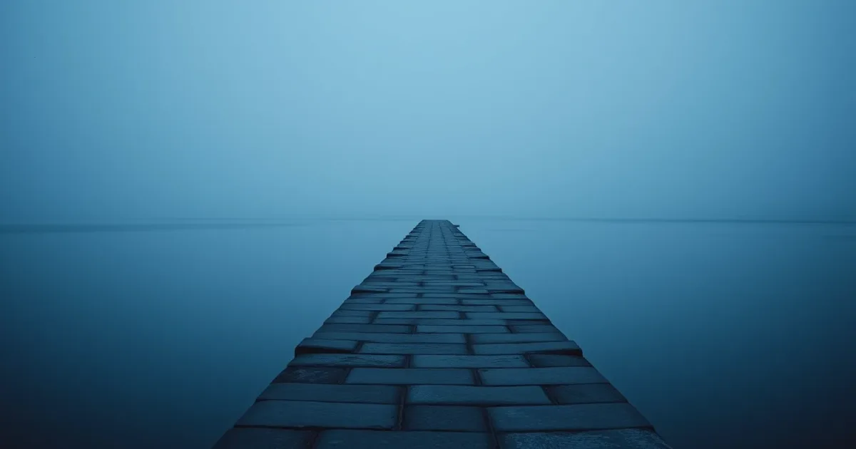 A stone causeway running out across still water at dusk, illustrating US interest withholding for UK residents
