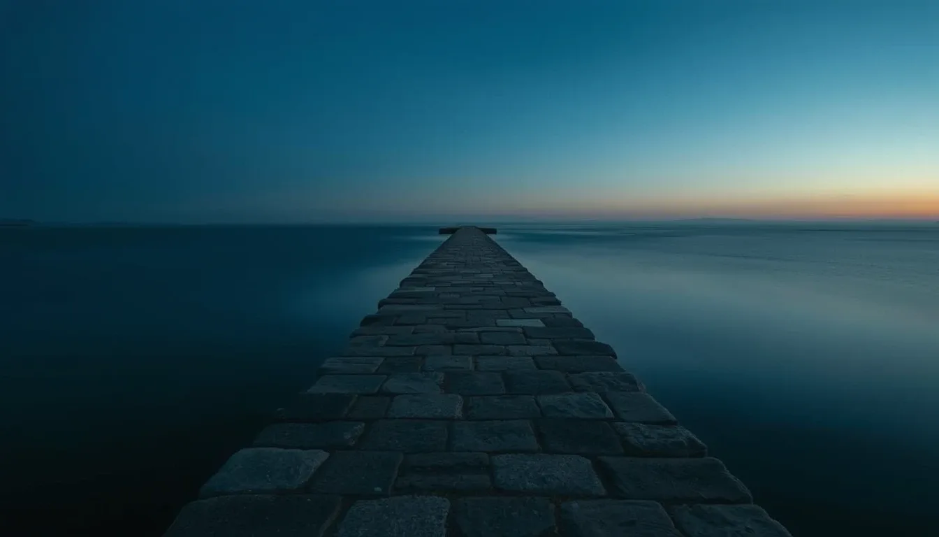 A stone causeway running out across still water at dusk, illustrating US interest withholding for UK residents