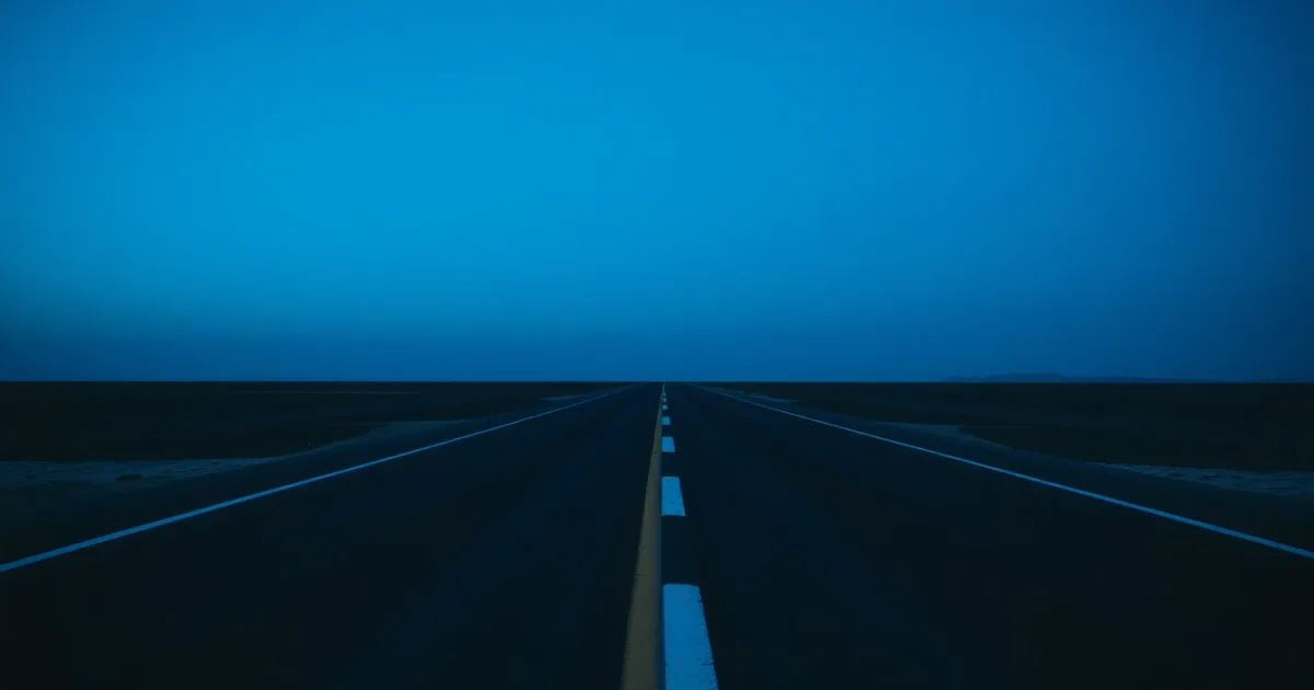 Two roads of different surfaces meeting on an empty plain, illustrating UK limited company: worth it?